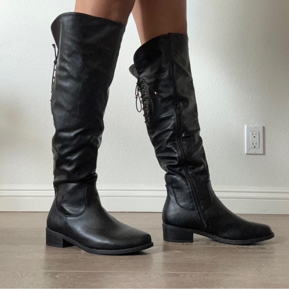 Black knee high boots with lace up detail